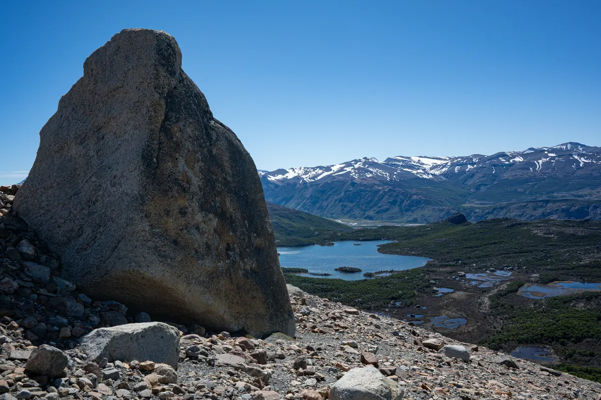 A boulder on the slope, with the valley below